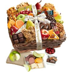 an assortment of fruit and sweets in a wicker basket