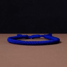 "◾ The handmade navy blue Tibetan bracelet for luck and protection is a beautifully crafted accessory, each knot is meticulously tied whos creates an amazing pattern. ✅ Adjustable bracelet - the slip knot lets you adjust the size. ➰ Sizes: S - Fully Closed - 5.9\"inches (15cm) / Full Opened - 9.8\"inches (25cm) M - Fully Closed - 6.6\"inches (17cm) / Full Opened - 10.6\"inches (27cm) L - Fully Closed - 7.4\"inches (19cm) / Full Opened - 11.4\"inches (29cm) 🟦 The color of the bracelet is navy blue. ◽ More colors and models are available in the shop. ◽ Just check out the shop. ✔️ Please note that due to the difference between different monitors, the image may not reflect the actual color of the item. ✍ If you have any questions please contact me." Adjustable Blue Woven Bracelets, Adjustable Blue Woven Bracelet, Adjustable Woven Blue Bracelets, Spiritual Handmade Blue Braided Bracelets, Blue Casual Bracelet For Meditation, Adjustable Blue Woven Braided Bracelet, Adjustable Blue Braided Bracelet, Casual Blue Bracelet For Meditation, Blue Woven Bracelets As A Gift