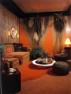 an orange living room with two palm trees hanging over the couches and coffee table