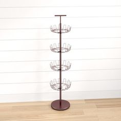 a tall metal rack with five cups on it's sides and four shelves in the middle