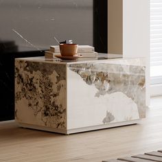 a marble table with a book on top and a coffee cup sitting on top of it