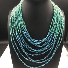 ON SALE Designer signed BARRERA Very pretty aqua glass 12 strand high and necklace in excellent vintage condition. Very pretty addition to any collection or wardrobe. Moonglow Necklace, Desert Hot Springs, Costume Jewelry Sets, Aqua Glass, Multi Strand Necklace, Glass Bead Necklace, Strand Necklace, Multi Strand, Hot Springs