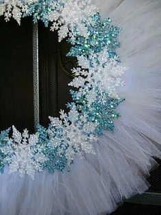 a white and blue wreath with snowflakes on it