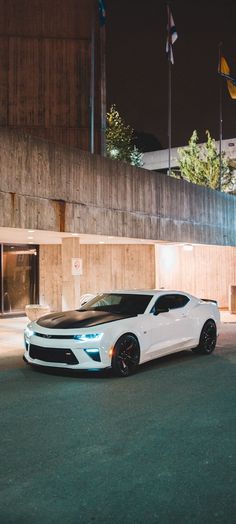 a white car parked in front of a building