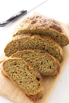 sliced loaf of bread sitting on top of a cutting board