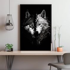 a black and white photo of two wolfs on a wall next to a table