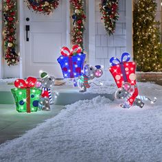 lighted christmas presents in front of a house