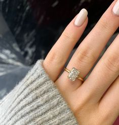 a woman's hand with a diamond ring on it