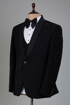 a black tuxedo with white shirt and bow tie on a mannequin