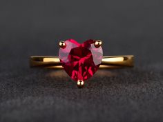 Welcome to my shop, you can find many beautiful gemstone jewelry here, and you also can ask for customized service. Main Stone: 8mm*8mm heart cut lab ruby Accent Stones: none Metal: 925 sterling silver plated with yellow gold. I also can provide metal options such as 14k solid yellow/white/rose gold Setting: prong setting More rings please go to my shop home: https://www.etsy.com/shop/XCjewelryStudio?ref=hdr_shop_menu It's a perfect gift for who born in July(birthstone),it's quite comfortable fo Ruby Wedding Rings, Heart Wedding Rings, Gemstone Diamond Ring, Garnet Engagement Ring, Ruby Wedding, Red Gemstones, Wedding Rings Unique, Rose Gold Metal, Red Ruby