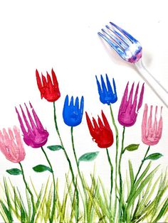 a painting of flowers and a fork with watercolors on the paper behind it