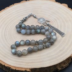 "Labradorite Gemstone Rosary, 33 Beads with 925 Sterling Silver Tassel, Turkish Prayer 33 Beads, Rosary, Tasbih, Tesbih, Tasbih, Sibha ✦ Details ✦ * Material: 925 Sterling Silver * Gemstone: Labradorite  * Bead : 33 Count * Bead Size: 10 mm * Silver weight: 13.10 grams * Total Length : 32 cm (12.60 Inches) * Length Without Tassel : 22 cm (8,66 Inches) ✦ Shipping ✦ * Processing time: 1-2 business days. * This item ships from my Turkish workshop in Istanbul. * Add your phone number in address box for a smoother delivery. That makes courier personnel's job easier.  ✦ Packaging ✦ * Comes with a luxury gift box and a jewellery cleaning cloth. ✦ Returns, Exchanges ✦ * Return option available for 30 days after the delivery. * The product has to be in the same shape, type, and material. * Personal Luxury Spiritual Silver Beads, Silver Beads With Natural Stones For Jewelry Making, Spiritual Silver 8mm Beads, Silver Rosary With Natural Stones For Gift, Silver Rosary With Natural Stones As A Gift, Silver Rosary With Natural Stones And Round Beads, Bohemian Silver Rosary For Jewelry Making, Silver Rosary With Natural Stones, Silver Round Beads With Natural Stones