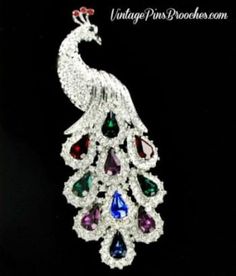 Beautiful Vintage Peacock Bird Pin Brooch Jewelry With Amethyst Purple, Pave Diamond,  Emerald Green,  Ruby Red, And Blue Sapphire Rhinestones. The Peacocks Entire Body Is Covered In Rhinestones. The Peacock Tail Consist Of Pear Shaped Rhinestones Mixed With Diamond Chaton Rhinestones. The Head Consist Of Three Red Rhinestones. The Peacocks Eye Contains One Emerald Green Rhinestone. Measurements: 3.7" Tall - 1.5" Tall. Excellent Vintage Condition. This rhinestone vintage peacock pin would look l Famous Actors And Actresses, Frog Brooch, Bowling League, Turquoise Necklaces, Purple Turtle, Peacock Tail, Necklaces Choker, Turtle Brooch, Vintage Peacock