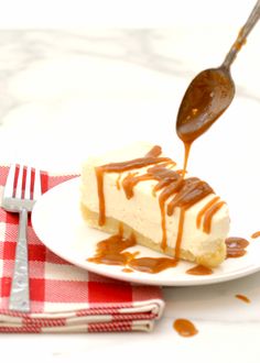 a piece of cheesecake with caramel sauce being drizzled on it