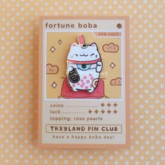 a pin with a cat on it sitting in front of a polka dot tablecloth