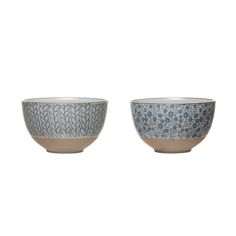 two blue and white bowls sitting next to each other