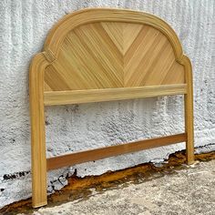 a close up of a wooden headboard against a wall