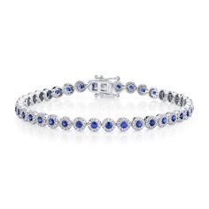 Rich in color, she will love the deep blue hues in this bracelet from Shy Creation. Crafted in 14k white gold, this bracelet features a row of blue sapphire gemstones surrounded by sparkling round diamonds in a halo motif. This bracelet measures 4.5mm in width and 7 inches in length. The diamonds are 1 1/4ctw, H in color, and SI2 in clarity.