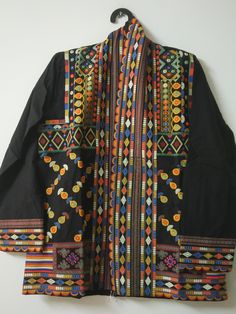 "Black Suzani partywear Long jacket Indian Cotton embroidery Coat Handmade Ladies embroidery dress Cotton kimono robe quilted Boho jacket  This stylish Embroidery Jacket crafted from a comfortable fabric, this eye-catching piece is perfect for any occasion. Its unique design features intricate details and embroidered patterns that are sure to make a statement. Easy to Carry, You Can Wear It on Your Party Attire, Daily Wear, You Can Use This as Beachwear, Lounge wear and as a Regular Outfit, This One Product Will Be Suitable for your Multiple Occasions. Wear it with any black and white dress, or with jeans to add color and beauty. Handmade in India. Size:-One size (plus) US women's letter Measurements: Length: 32\" Inches Bust : 44\" Inches Sleeve : 20\" Inches Color : Same As Picture Fabri Traditional Spring Kimono With Intricate Embroidery, Traditional Black Festive Kimono, Traditional Black Outerwear For Festivals, Traditional Kimono With Multicolor Embroidery For Spring, Traditional Spring Kimono With Multicolor Embroidery, Traditional Fall Festival Kimono, Traditional Festive Fall Kimono, Traditional Fall Festive Kimono, Traditional Festive Outerwear With Geometric Embroidery