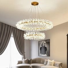 a living room with a couch, chair and chandelier hanging from the ceiling