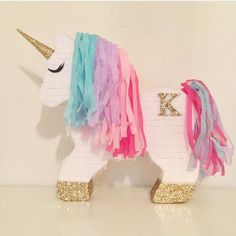 a unicorn made out of tissue paper and some gold glitter