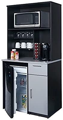 a black and silver refrigerator freezer sitting next to a small table with drinks on it