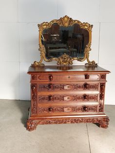 an antique dresser with a mirror on top