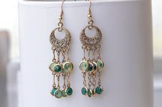 Green Gold Fringes Earrings, Dangle Earrings,  Gipsy Earrings, TASSEL Earrings, Emerald And Peridot, Brass Gold Vintage Daily Earrings Gift   Details of item: Metal: Brass and gold plated - nickel free Gemstone:  Crystal Length: 3 inches Width: 0.6 inches The  earrings will be packed in a gift box. FOR MY EARRINGS COLLECTION HERE: https://www.etsy.com/il-en/shop/rebekajewelry?section_id=14222612&ref=shopsection_leftnav_3 TO GET TO MY SHOP: https://www.etsy.com/il-en/shop/rebekajewelry THANK YOU FOR CHOOSING MY ETSY SHOP REBEKA Elegant Green Dangle Plug Earrings, Green Dangle Earrings For Pierced Ears, Green Dangle Hoop Earrings, Elegant Green Chandelier Earrings In Brass, Elegant Green Brass Chandelier Earrings, Vintage Green Earrings With Dangling Beads, Green Dangle Crystal Earrings, Green Round Chandelier Earrings As Gift, Green Round Chandelier Earrings For Gift