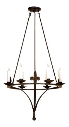 an iron chandelier with six candles hanging from the bottom, and four lights on each side