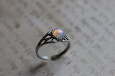 This petite and elegant ring is perfect for Fall and Winter. It's beautiful and makes a very sweet gift for someone you love. The white fire opal in this ring is true vintage from the 1950's, and is set in a lace edge setting on a sterling silver plated ring base. Your setting will be solder set to the ring. The ring base can be set from a size 5 to a size 9.5. Once we have set the ring, you can still make minor adjustments. These are rare stones making this ring a Limited Edition. Retails for o Dainty Silver Opal Ring For Gift, Dainty Silver Opal Ring As A Gift, Elegant Nickel-free Opal Ring For Gift, Silver Opal Ring Nickel-free For Gift, Nickel-free Silver Opal Ring As Gift, Nickel-free Silver Opal Ring Gift, White Opal Ring Gift, Dainty Sterling Silver Opal Ring For Gift, Delicate Oval Opal Ring As Gift