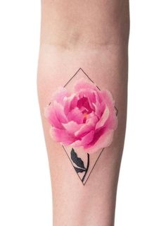 a pink flower is on the leg of a woman's leg, with an instagram