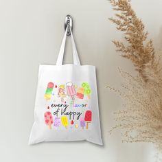 This Popsicle Every Flavor of Happy 🍢🍉White Tote Bag is the ultimate mood-lifter! Perfect for any summer getaway from beach days and vacations to school trips, this colorful design bag will add a pop of fun wherever you go! This bag is a perfect way to showcase a bit of your personality! It is practical, stylish and environmentally friendly reusable. We hand press each item with love and care. 💙▸ Dimensions are approximately 15"W x 16"H with 10" handles▸ Material: Polyester canvas▸ Print: Sub White Large Capacity Bag For Back To School, White Tote Shoulder Bag For Back To School, White Shoulder Bag For Everyday And Back To School, White Canvas Bag For Everyday, Back To School, Fun White Shoulder Bag For School, White Everyday Bags For Back To School, Trendy White Shoulder Bag For Back To School, White Summer Canvas Shopping Bag, White Summer Canvas Bag For Shopping