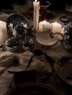 a table topped with candles and disco balls