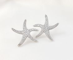 "These cubic zirconia starfish stud earrings are made with your choice of gold, rose gold or silver finish. These sparkly 1-inch star fish earrings are perfect for beach weddings and make a great bridesmaid ask or bridal party gift. The posts on these nautical earrings are at the top of the back of the stud earring. Thank you for looking.   For the matching necklace: https://www.etsy.com/listing/581787868/new-starfish-necklace-rose-gold-beach?click_key=ac9e4a110acd106ffe2b02f3e39a483877ea19e4%3A Bridesmaid Ask, Rhodium Jewelry, Nautical Earrings, Beach Themed Wedding, Fish Earrings, Asking Bridesmaids, Gold Beach, Etsy Boutique, Earrings Beach