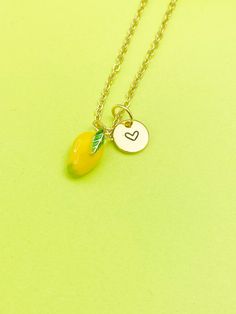 This is gold tone yellow mangoes charm with hand stamped initial charm on brass/stainless steel 18 inches chain. ♥ You will receive 1 necklace. HOW TO ORDER 1) Select the quantity 2) Select the initial  3) Add to cart DESCRIPTION ♥ Necklace, Gold Plated over Brass or Stainless-steel Cable Chain with Lobster Claw Clasp, Size: about 17.7 inches (45cm) long, 1-2mm wide, Nickel Safe, ♥ Initial Charms, Gold Plated over Stainless steel, Size: about 8-10mm in diameter, 1mm thick, Nickel Safe, ♥ Mangoes Charm, Brass Enamel Charms, Imitation Fruit, Light Gold, Mangoes Charm, Gold, Size: about 0.30 inch(7.5mm) wide, 0.47 inch(12mm) long, 0.31 inch(8mm) thick, ♥ We are happy to help with any situation so please reach out with any concerns. ♥ Materials from the USA and international sourcing. ♥ I do n Dainty Yellow Charm Necklace For Gifts, Personalized Gold Charms For Gift, Yellow Pendant Charm Necklace For Gift, Gold Hand Stamped Charm Necklace For Birthday, Yellow Dangle Necklaces As Gifts, Personalized Yellow Charm Necklaces For Gift, Personalized Yellow Charm Necklace As Gift, Personalized Yellow Charm Necklace For Gift, Adjustable Cadmium-free Charm Necklace For Gift