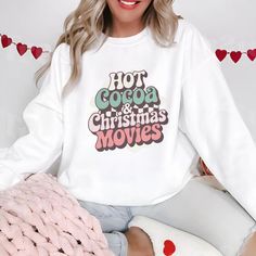 Hot Cocoa & Christmas Movies Sweatshirt, Winter Sweatshirt, Womens Winter Gift Ideal For Any Situation, A Unisex Heavy Blend Crewneck Sweatshirt Is Pure Comfort. These Garments Are Made From Polyester And Cotton. This Combination Helps Designs Come Out Looking Fresh And Beautiful. The Collar Is Ribbed Knit, So It Retains Its Shape Even After Washing. There Are No Itchy Side Seams On These Sweaters. .: Made With A Medium-Heavy Fabric Blend Of 50% Cotton And 50% Polyester (8.0 Oz/Yd (271.25 G/M)), White Letter Print Cozy Top, Cozy White Tops With Letter Print, Cute White Christmas Sweatshirt, White Christmas Sweatshirt For Loungewear, Christmas White Sweatshirt For Loungewear, White Letter Print Sweatshirt For Holidays, Cute White Christmas Sweater, Cozy White Tops With Graphic Print, Cozy White Top With Graphic Print