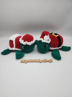 two crocheted sea turtles with santa hats on their heads and the words congratulations written below them