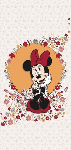 the mickey mouse is sitting in front of flowers and has a red bow on his head