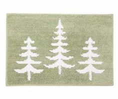 a green rug with white trees on it