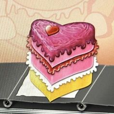 a heart shaped cake sitting on top of a table