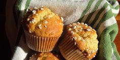 three muffins sitting on top of a green and white towel