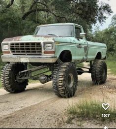 an old pick up truck on a dirt road