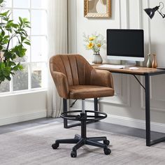 an office chair sits in front of a desk with a computer monitor and keyboard on it