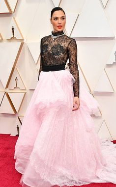 a woman in a pink and black dress on the red carpet at an oscars