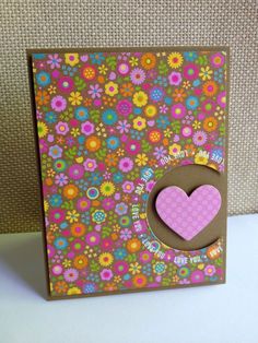 an image of a card with a heart in the middle and flowers all over it