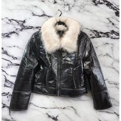 This Unreal Fur Aviator Jacket In Size Large Is A Must-Have Addition To Any Fashion-Forward Woman's Wardrobe. The Sleek Black Polyurethane Outer Shell Exudes Sophistication, While The Zip Closure And Short Length Offer A Modern Edge. The Jacket Features An On-Trend Aviator Style With Beautiful Faux Fur Colar And Is Perfect For Layering Over Any Outfit. The Brand, Unreal Fur, Is Known For Its Commitment To Cruelty-Free Fashion, Making This The Perfect Option For Conscious Consumers. This Jacket I Trendy Winter Party Leather Jacket, Luxury Winter Biker Jacket With Zipper Closure, Winter Party Leather Jacket With Zipper Closure, Winter Party Leather Jacket With Zipper, Trendy Fitted Leather Jacket With Faux Fur Lining, Fitted Trendy Leather Jacket With Faux Fur Lining, Winter Party Leather Biker Jacket, Winter Party Faux Leather Outerwear, Trendy Faux Leather Jacket With Faux Fur Trim