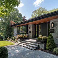 a modern house with stone steps leading to the front door