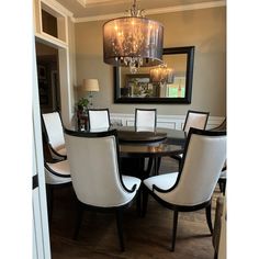 a dining room table with chairs and a chandelier