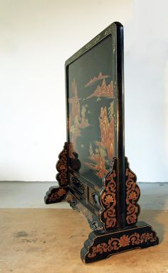 an ornately decorated black and gold clock on display