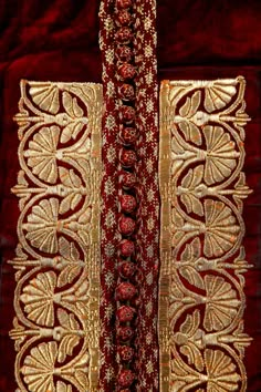 red and gold fabric with intricate designs on it